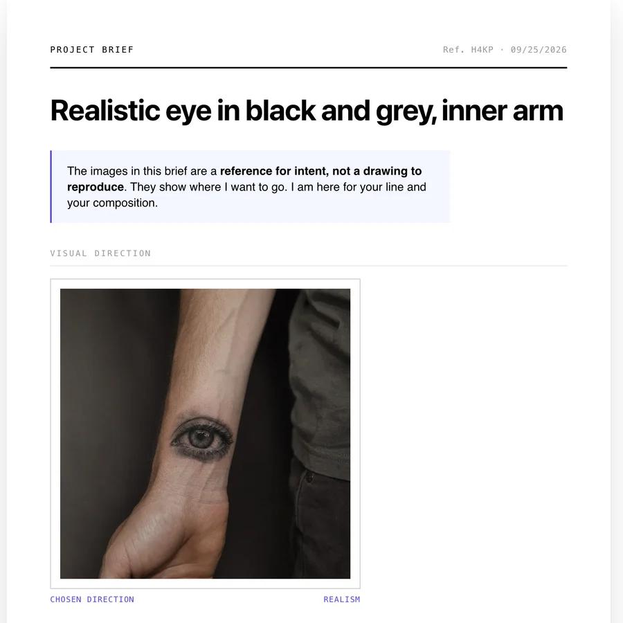 Top of a tattoo brief: project title, a note stating the images are a reference for intent and not a drawing to reproduce, and a photo of a realistic eye tattooed in black and grey on the inner arm.
